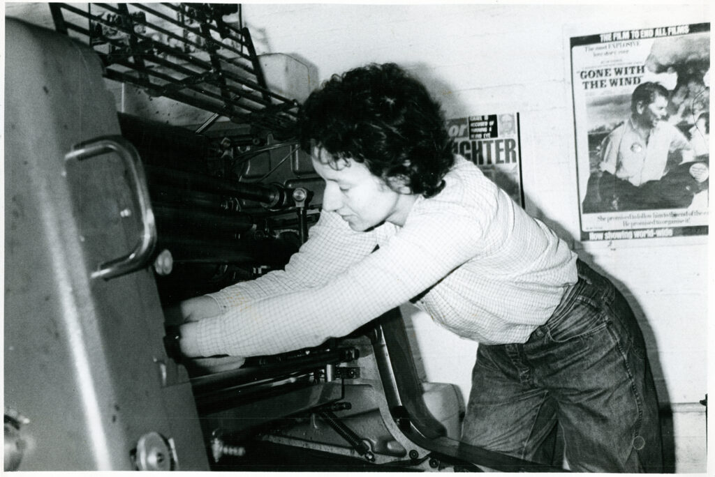 Woman working on printing press